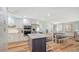 Bright kitchen features white cabinets, stainless steel appliances, and an island with granite countertops at 4234 Gulf Of Mexico Dr # Q2, Longboat Key, FL 34228
