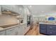 Well-equipped kitchen with stainless steel appliances, white cabinets, and an open layout to the living area at 4234 Gulf Of Mexico Dr # Q2, Longboat Key, FL 34228