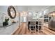 Well-lit kitchen with white cabinets, stainless appliances, a breakfast bar, and modern finishes at 4234 Gulf Of Mexico Dr # Q2, Longboat Key, FL 34228