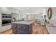 Bright kitchen features white cabinets, stainless steel appliances, and an island with granite countertops at 4234 Gulf Of Mexico Dr # Q2, Longboat Key, FL 34228