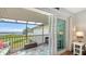 Relaxing screened lanai with seating, a coffee table, and scenic waterfront views at 4234 Gulf Of Mexico Dr # Q2, Longboat Key, FL 34228