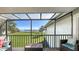 Serene screened lanai offering views of the manicured lawn and tranquil bay at 4234 Gulf Of Mexico Dr # Q2, Longboat Key, FL 34228