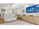Comfortable living room area with stylish built-ins, a large TV, and a neutral color scheme at 4234 Gulf Of Mexico Dr # Q2, Longboat Key, FL 34228