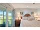Main bedroom with a queen size bed and access to the lanai and outdoor space at 4234 Gulf Of Mexico Dr # Q2, Longboat Key, FL 34228