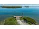 Scenic aerial view of a pier with an American flag in a serene waterway setting at 4234 Gulf Of Mexico Dr # Q2, Longboat Key, FL 34228