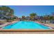 Community pool with clear blue water and plenty of lounge chairs and umbrellas at 4234 Gulf Of Mexico Dr # Q2, Longboat Key, FL 34228