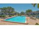 Inviting community pool with ample seating, sun umbrellas and manicured landscaping at 4234 Gulf Of Mexico Dr # Q2, Longboat Key, FL 34228