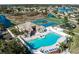 Aerial view of a community clubhouse with a pool, tennis, and basketball courts nestled among scenic waterways and green spaces at 4509 Halls Mill Xing, Ellenton, FL 34222