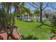 Expansive green backyard with pond views and lush landscaping at 4509 Halls Mill Xing, Ellenton, FL 34222