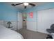 Tranquil blue bedroom with closet, lamp, and chair near the window at 4509 Halls Mill Xing, Ellenton, FL 34222