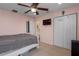 Bright bedroom with ceiling fan, TV, and closet with white double doors at 4509 Halls Mill Xing, Ellenton, FL 34222