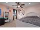 Comfortable bedroom with natural light, ceiling fan, and neutral carpet at 4509 Halls Mill Xing, Ellenton, FL 34222