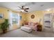 Cozy bedroom with natural light, ceiling fan, and comfortable seating area at 4509 Halls Mill Xing, Ellenton, FL 34222