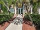 Building entrance with large glass doors, columns, and mature landscaping at 4509 Halls Mill Xing, Ellenton, FL 34222