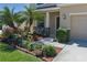 Beautifully landscaped front yard featuring lush plants, mulch, and a cozy seating area at 4509 Halls Mill Xing, Ellenton, FL 34222
