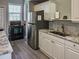 Galley kitchen with stainless steel appliances, granite countertops, and white cabinets at 4509 Halls Mill Xing, Ellenton, FL 34222