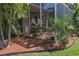 Screened lanai featuring a dining area, plants, and peaceful outdoor ambiance at 4509 Halls Mill Xing, Ellenton, FL 34222