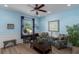 Bright living room features fresh paint, wood flooring, a ceiling fan, and modern decor at 4509 Halls Mill Xing, Ellenton, FL 34222