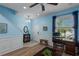 Bright living room featuring fresh paint, wood flooring, a ceiling fan, and a staircase at 4509 Halls Mill Xing, Ellenton, FL 34222