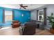 Comfortable living room showcasing modern furniture, bright blue accent wall, and neutral toned flooring at 4509 Halls Mill Xing, Ellenton, FL 34222