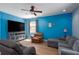 Living room with a media center, large-screen television, and comfortable seating arrangement at 4509 Halls Mill Xing, Ellenton, FL 34222