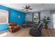 Living room featuring a blue accent wall, neutral colored seating, and a view to the exterior at 4509 Halls Mill Xing, Ellenton, FL 34222