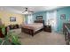 Bright main bedroom with aqua and yellow walls, ceiling fan and carpet at 4509 Halls Mill Xing, Ellenton, FL 34222