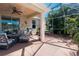 Screened-in patio with seating, grill, and tropical landscaping surrounding the area at 4509 Halls Mill Xing, Ellenton, FL 34222