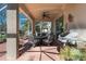 Covered patio with comfortable seating, ceiling fan, outdoor grill, and views of the backyard at 4509 Halls Mill Xing, Ellenton, FL 34222