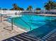 A refreshing community swimming pool with multiple access points, surrounded by lounge chairs at 4509 Halls Mill Xing, Ellenton, FL 34222