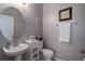 Elegant powder room with pedestal sink, decorative mirror, and stylish patterned wallpaper at 4509 Halls Mill Xing, Ellenton, FL 34222