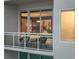 Intimate balcony with chairs overlooking city skyline seen through sliding glass doors at 540 N Tamiami Trl # 1503, Sarasota, FL 34236