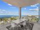 This spacious balcony features a dining table and seating area with amazing views of the bay at 540 N Tamiami Trl # 1503, Sarasota, FL 34236