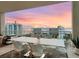 Expansive balcony with a dining set offers stunning sunset views of the water and city skyline at 540 N Tamiami Trl # 1503, Sarasota, FL 34236