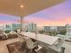 Spacious balcony with dining and lounge areas overlooks the city skyline and tranquil waterfront at 540 N Tamiami Trl # 1503, Sarasota, FL 34236