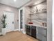 Dry bar area featuring a beverage refrigerator and a marble countertop at 540 N Tamiami Trl # 1503, Sarasota, FL 34236