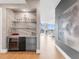Hallway bar area with a wine fridge, shelving, and adjacent living space at 540 N Tamiami Trl # 1503, Sarasota, FL 34236