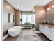 Modern bathroom with a soaking tub, walk-in shower, and geometric wallpaper at 540 N Tamiami Trl # 1503, Sarasota, FL 34236