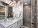 Sleek bathroom featuring a marble countertop vanity and a glass-enclosed shower with gray tiling at 540 N Tamiami Trl # 1503, Sarasota, FL 34236