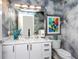 Stylish powder room featuring a marble vanity and artistic decor at 540 N Tamiami Trl # 1503, Sarasota, FL 34236