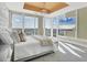 Brightly lit bedroom featuring floor-to-ceiling windows, a ceiling medallion, and a wall-mounted TV at 540 N Tamiami Trl # 1503, Sarasota, FL 34236