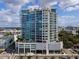 Modern condo building with expansive glass windows, multiple balconies and lush landscaping at 540 N Tamiami Trl # 1503, Sarasota, FL 34236