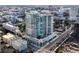 Modern high rise condo building featuring floor to ceiling glass windows and manicured landscaping at 540 N Tamiami Trl # 1503, Sarasota, FL 34236