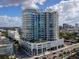 Modern condo building with expansive glass windows, multiple balconies and lush landscaping at 540 N Tamiami Trl # 1503, Sarasota, FL 34236
