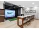 Entertainment room featuring a golf simulator and stylish seating area at 540 N Tamiami Trl # 1503, Sarasota, FL 34236