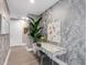 Stylish hallway featuring a decorative desk, modern artwork, and elegant wallpaper at 540 N Tamiami Trl # 1503, Sarasota, FL 34236