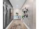 Elegant hallway featuring unique wall art, decorative lighting, and hardwood flooring at 540 N Tamiami Trl # 1503, Sarasota, FL 34236