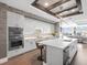 Bright kitchen with white cabinets, stainless steel appliances, quartz countertops and an island with barstool seating at 540 N Tamiami Trl # 1503, Sarasota, FL 34236