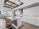 Modern kitchen with white cabinets, quartz countertops, and stainless steel appliances, and seating at the island at 540 N Tamiami Trl # 1503, Sarasota, FL 34236