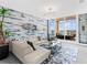 Bright living room with modern decor, stylish furniture, and access to a balcony with beautiful views at 540 N Tamiami Trl # 1503, Sarasota, FL 34236